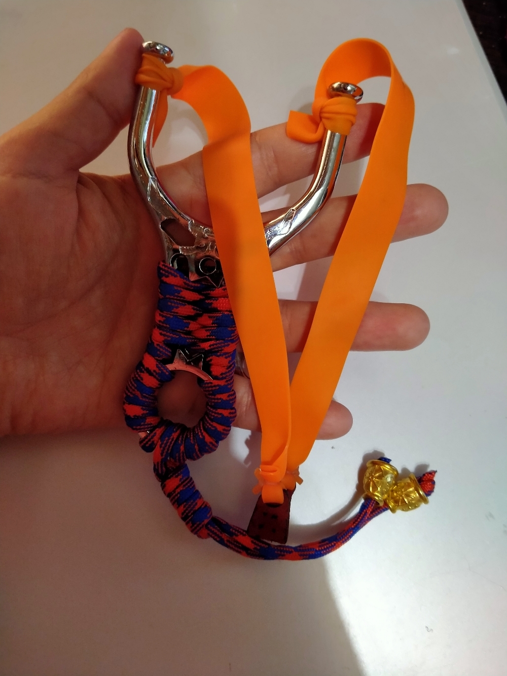 Фотография покупателя товара Рогатка, ленточный жгут оранжевый, рукоять металл в красно-синей оплетке, 7,5*13 см - Фото 1