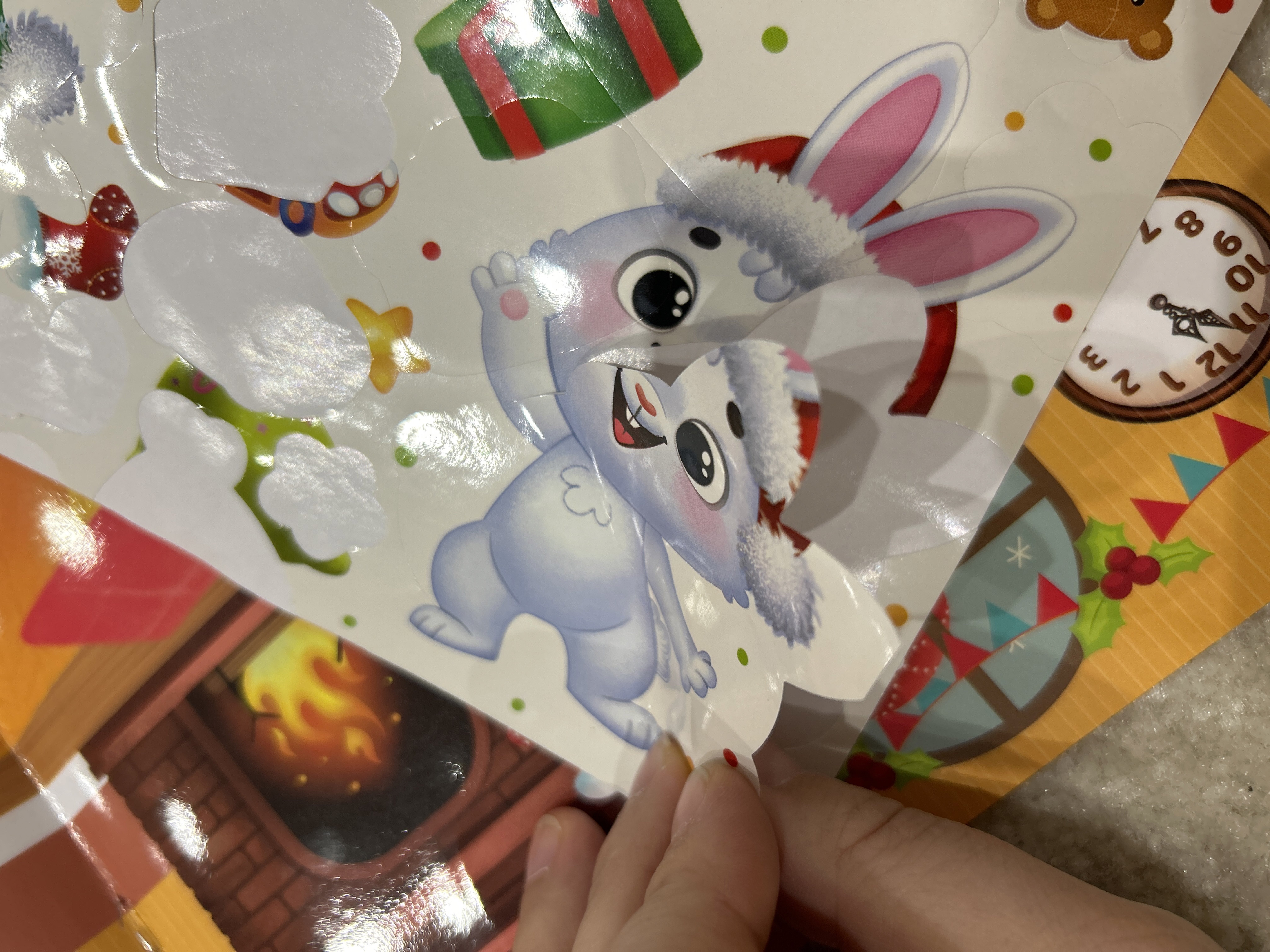 Фотография покупателя товара Книга с многоразовыми наклейками «Мои весёлые наклейки. Новогодние хлопоты. Зайчонок», А4, более 60 стикеров - Фото 1