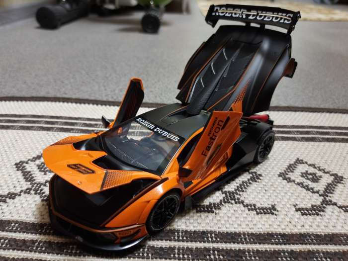 Фотография покупателя товара Машинка металлическая «Купе», 1:24, открываются двери, капот, багажник, инерция, цвет оранжевый - Фото 1